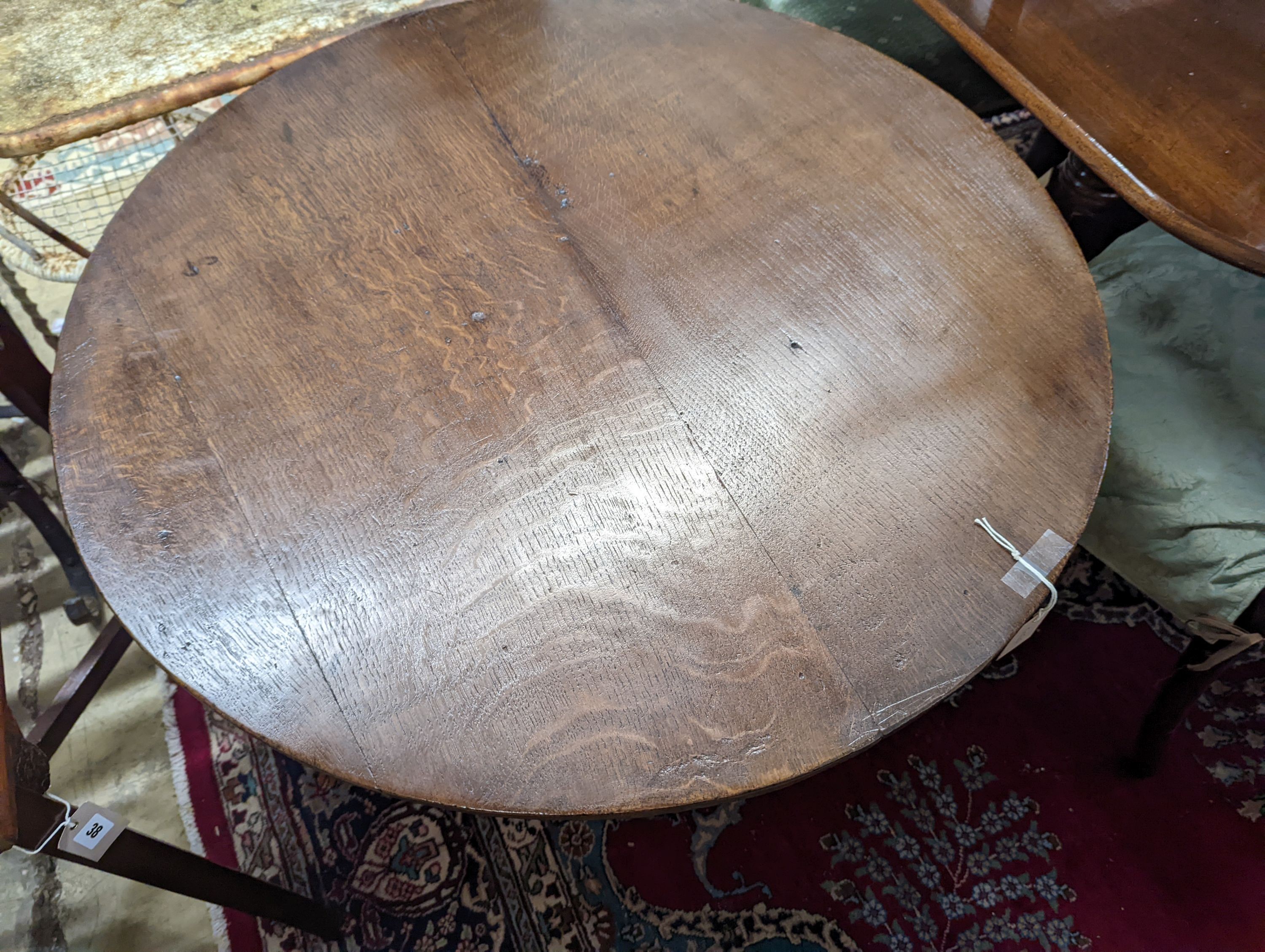 A George III circular oak tilt top tea table, diameter 86cm, height 71cm